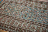 Distressed vintage Caucasian rug with dusty blue geometric floral field and wide crab style border.