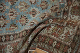 Distressed Caucasian runner detail showing faded red, dusty blue geometric patterns and crab border.