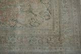 Distressed Bijar carpet pile, pale terracotta and teal floral motifs, foundation showing.