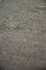 Distressed vintage Persian Bijar rug, showcasing worn pile and faint rose, teal, beige motifs.