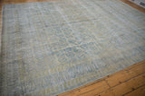 Faded vintage Meshed rug with distressed pale blue paisley pattern and visible foundation.