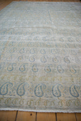 Pale blue boteh paisley motifs on distressed vintage Meshed carpet, foundation showing.