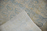 Distressed pile of vintage Meshed rug, revealing foundation wear and hand-knotted backing.