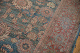 Vintage Distressed Mahal carpet's denim blue floral field and geometric brick red border detail.