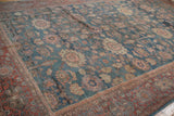 Textured denim blue field, varying floral palmettes, and ornate brick red Mahal border.