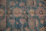 Distressed Mahal carpet pile detail, faded floral palmettes in blue, brick red, and sand.
