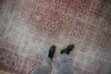 Distressed texture of antique Amritsar rug showing ivory, dusty raspberry Mahi Herati design.
