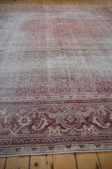 Faded dusty raspberry and ivory Mahi Mahi Herati motif on distressed antique Amritsar rug.