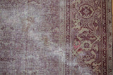 Distressed Amritsar carpet with Mahi Mahi Herati pattern, dusty aubergine, beige tones, and visible texture.