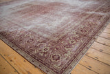 Distressed antique Amritsar rug corner, showing worn dusty aubergine Mahi Mahi Herati design.