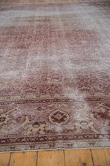 Distressed dusty raspberry and beige Amritsar carpet border with Herati pattern.