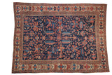 Antique Heriz carpet, early 20th century, with primitive bird and floral design in navy, brick red, and ivory.