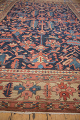 Antique Heriz border detail with ivory ground, brick red and sapphire blue geometric motifs, short fringe.
