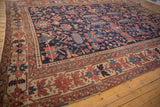 Antique Heriz carpet border with primitive serrated leaves and floral cross-sections in red and blue.