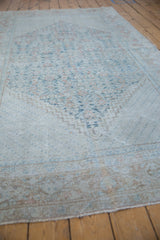 Distressed vintage Mahal carpet with faded dusty teal, blush, and beige geometric vinery.