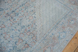Distressed vintage Mahal rug with dusty teal, brick red geometric vinery and worn pile.