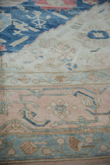 Distressed Oushak carpet pile showing mostly even wear and soft indigo, rose, ivory tones.