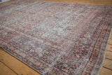 Distressed Khorassan rug detail, blush and ivory floral vinery showing mostly even wear.