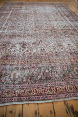 Intricate blush, red, and ivory floral vinery and border patterns on a distressed Khorassan rug.