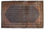 Vintage Persian Lilihan carpet with an allover Herati pattern on a navy blue field and dusty blush spandrels.