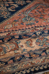 Detailed view of the hand-knotted pile revealing the intricate Herati design in navy and dusty blush.