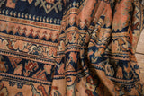 Close-up on the soft folds of a vintage Lilihan carpet, revealing the dense pile and dusty blush motifs.