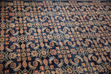 Detailed texture of the repeating Herati design with dusty blush and ivory accents on a navy blue wool pile.