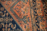Repeating Herati design with serrated leaves and floral elements in navy blue and dusty blush.