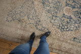 Distressed vintage Khotan rug runner, dusty navy floral vinery over exposed ivory foundation.