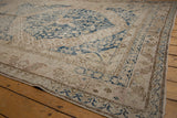 Distressed Khotan runner corner with reciprocating pawn floral border in faded ivory and blue.