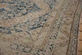 Distressed Khotan rug runner detail: faded navy blue floral patterns on ivory, foundation visible.