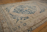 Distressed vintage Khotan runner border detail with dusty navy pawn floral motif.