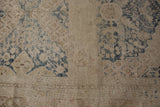 Distressed Khotan rug runner, visible foundation, faded navy floral pattern, aged texture.