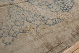 Distressed vintage Khotan runner, showing worn dusty navy blue floral patterns and visible foundation.
