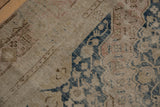 Distressed vintage Khotan runner, revealing dusty navy floral patterns and textured ivory foundation.