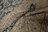 Faded dusty navy floral pattern and exposed foundation on distressed Khotan rug runner.