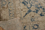 Close-up of Khotan rug foundation showing through distressed ivory and dusty navy pile.