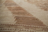 Distressed Oushak rug pile with stepped geometric patterns in antique ivory and pale coffee brown.