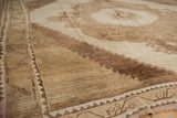 Distressed Oushak rug detail showing stepped spandrel patterns in ivory, beige, and coffee.