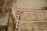 Intact side selvage, short pile, and stepped pattern on the distressed Oushak carpet.