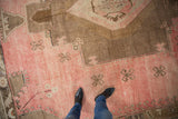 Distressed vintage Oushak rug with blush field, coffee brown abrash, and crab style motifs underfoot.