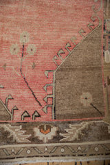 Distressed blush field with stepped coffee brown geometric border and ivory florals.