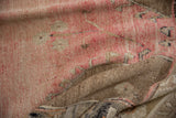Distressed Oushak rug with blush pink and pale coffee brown abrash, revealing woven foundation.