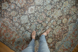 Distressed Mahal carpet showing faded allover floral pattern and Herati-inspired border details.