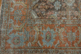 Distressed Mahal carpet close-up, showing worn rust, blue, olive floral pattern with exposed foundation.