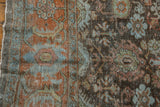 Distressed vintage Mahal carpet with time-softened rust, dusty blue florals, and visible foundation.