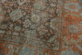 Distressed Mahal carpet detail: rust Herati border and dusty blue floral field.
