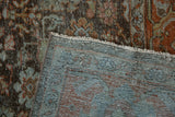 Distressed Mahal rug close-up revealing intricate floral pile, exposed foundation, and soft blue backing.