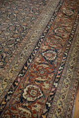 Vintage Tabriz carpet detail with classic Samovar turtle border and repeating navy Herati field.