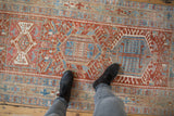 Distressed Karaja runner pile with geometric patterns in pale cherry red and sky blue.